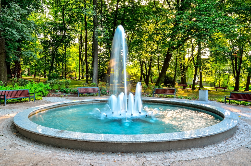 Nice fountain in the urban park. Green park in the city of Chrzanow, Poland.